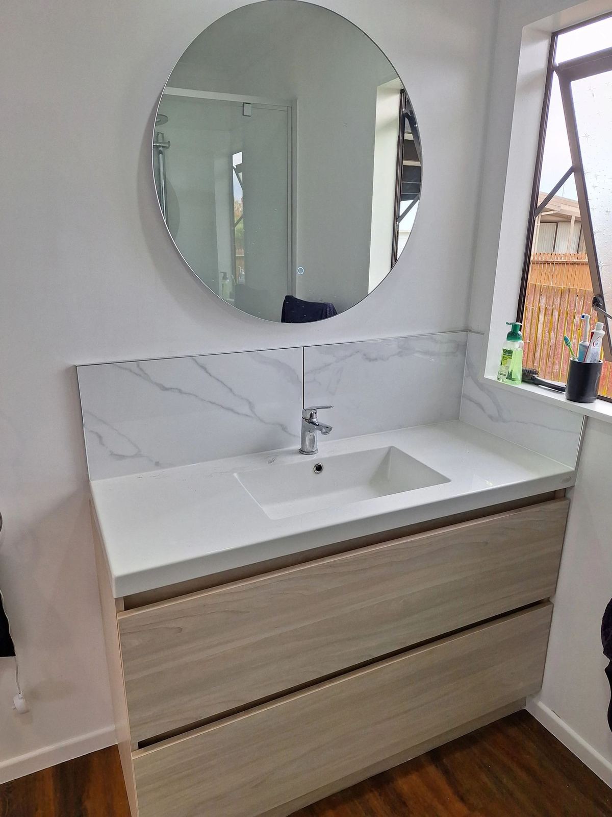 Bathroom vanity with round mirror